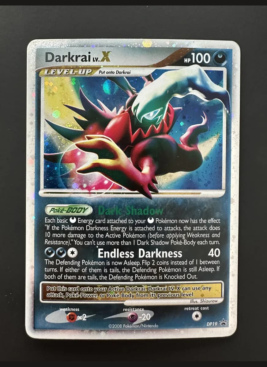 Darkrai Lv.X photographed on a black background