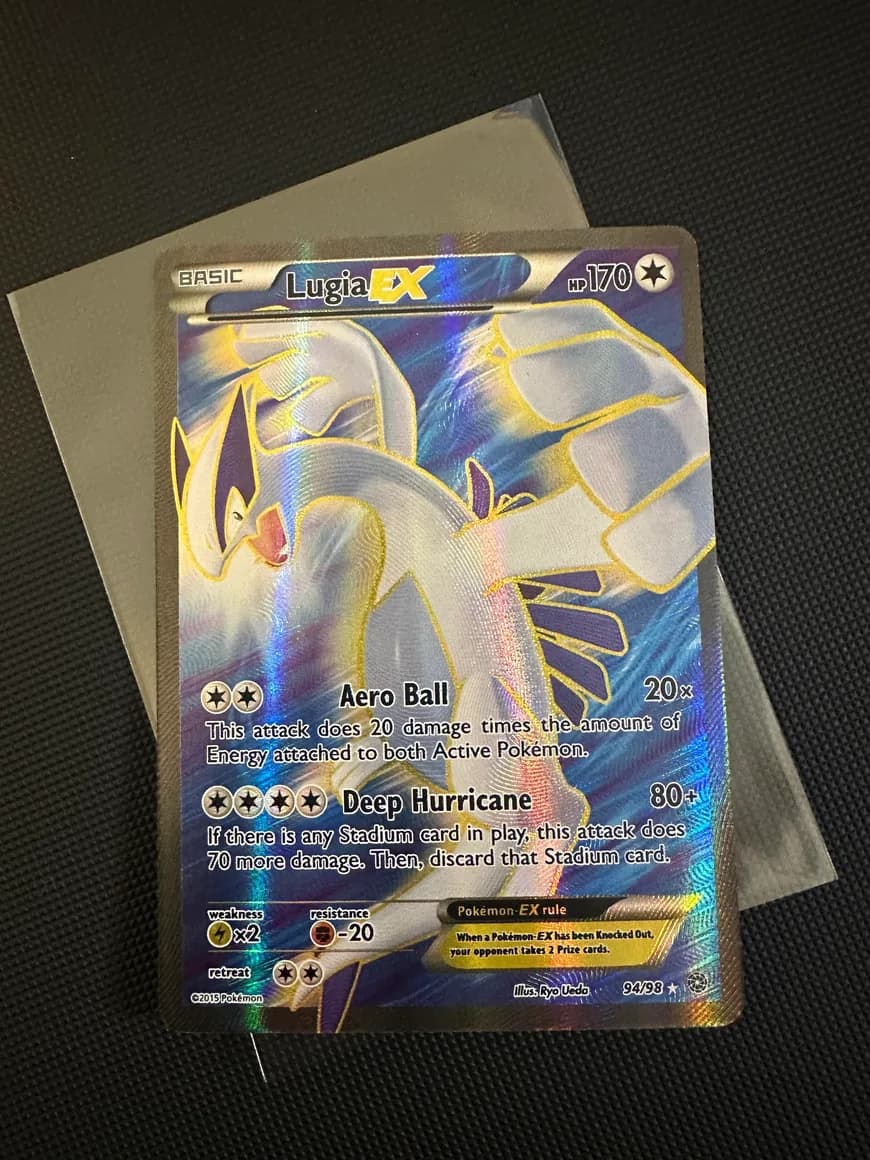 Lugia EX photographed on a textured mat