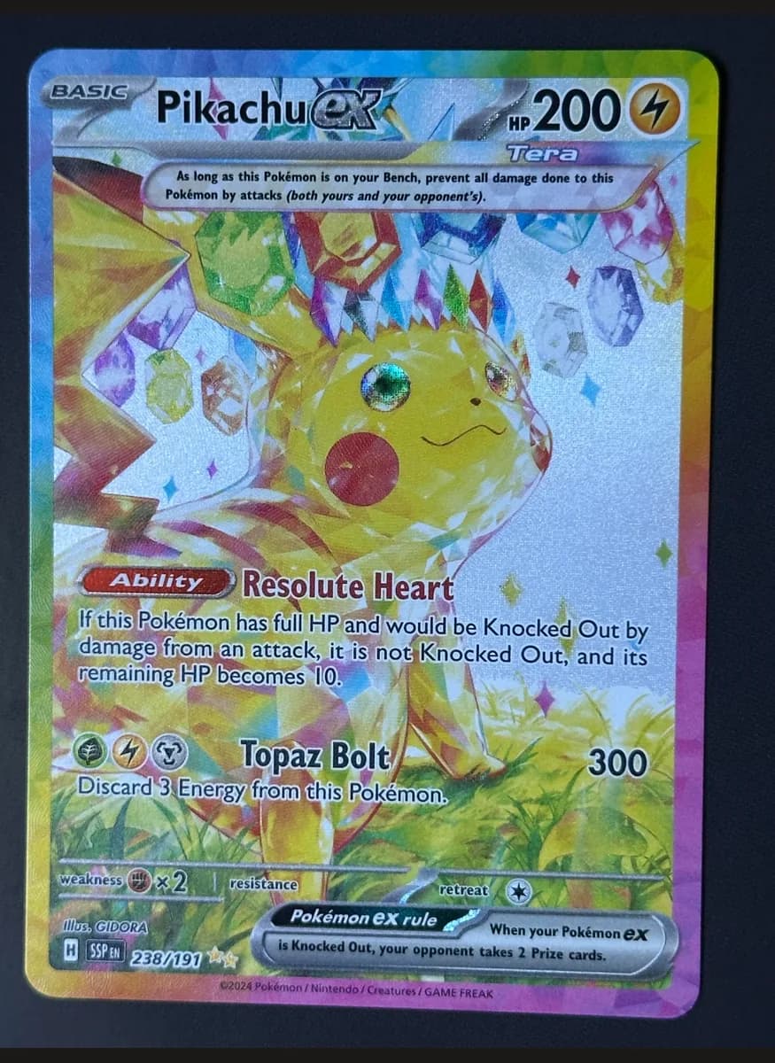 Pikachu ex (Tera) photographed on a black background